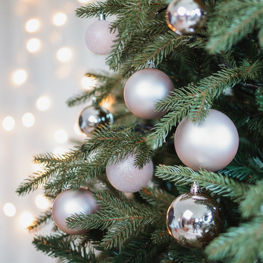 Pink set Christmas baubles in storage tube